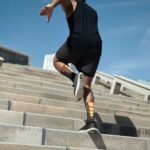 back-view-of-african-american-jogger-dressed-in-black-sportswear-and-sneakers-doing-workout-jumpin.jpg
